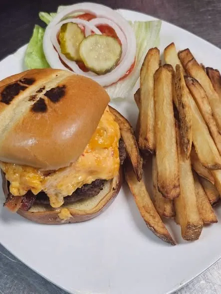 Bacon pimento cheeseburger on a brioche bun with hand-cut fries